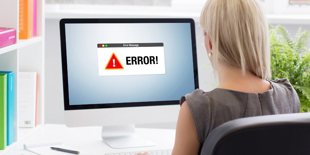 a lady sitting in front of her desktop with the words "error" on it